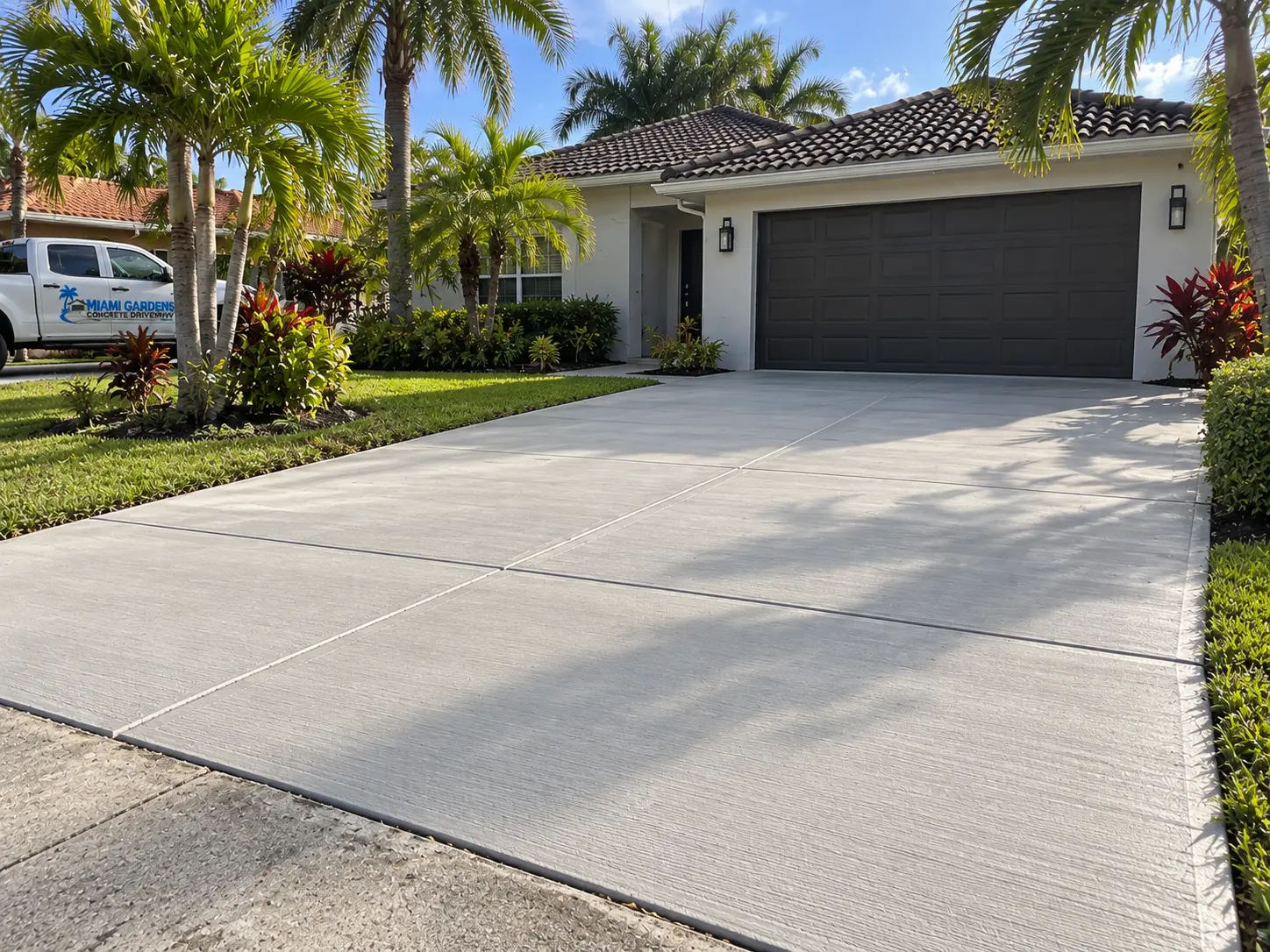 Finished residential concrete driveway photographed from the street edge toward the house